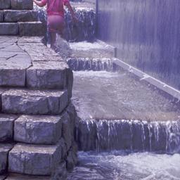 Child climing water feature.