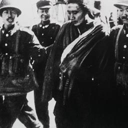 Tibetan man being escorted ...