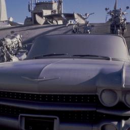 Gray vehicles on undulating...
