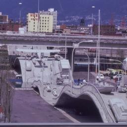 Gray vehicles on undulating...