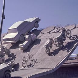 Gray vehicles at end of und...