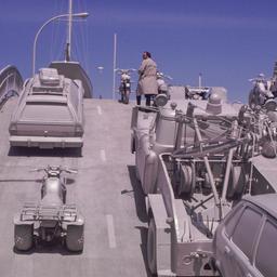 Gray vehicles on undulating...
