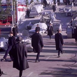 People in overcoats and hat...