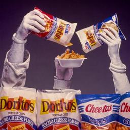 Hands emerging from chip bags.