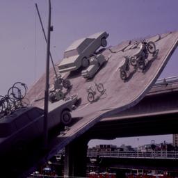 Gray vehicles on undulating...