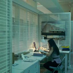 Interior view, woman at desk.