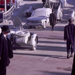 People in overcoats and hat...