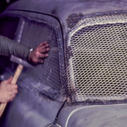 Man putting metal mesh over...