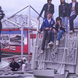Teenagers on top of gray tr...