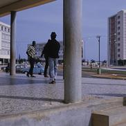 SICAP new housing, men walk...