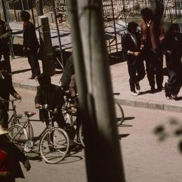 Tibetan men riding bicycles...