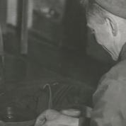 A man is fixing a machine part