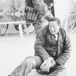 Soldier pulling arrested ma...