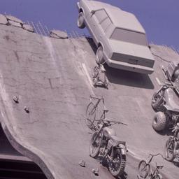 Gray vehicles at end of und...