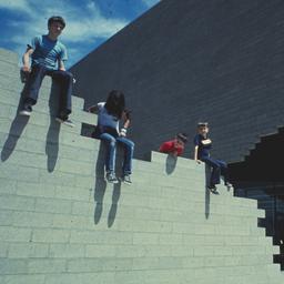 Exterior view, children sit...