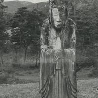 A stone statue of a man dre...