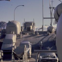 Gray vehicles on undulating...