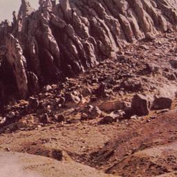 Rock outcrop, vehicle in fo...