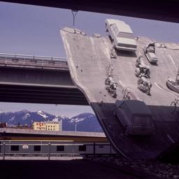 Gray vehicles at end of und...
