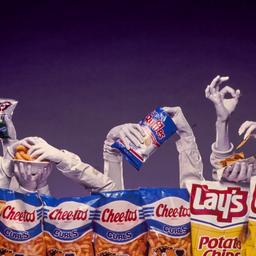 Hands emerging from chip bags.