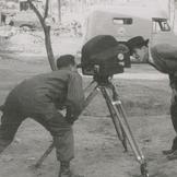Two men looking into the ca...