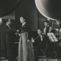 A woman singer dressed in h...