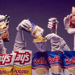 Hands emerging from chip bags.