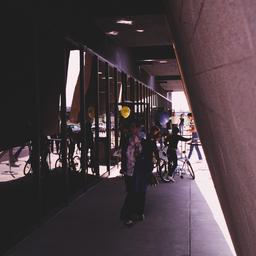 Exterior view, people stand...