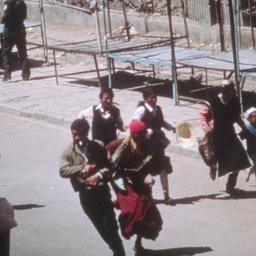 Tibetans running past deser...
