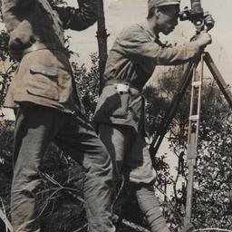 Chinese Men Surveying With ...