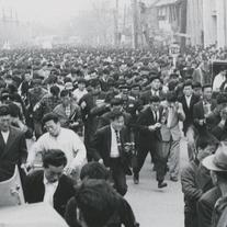 Mass of protesters running ...