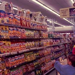Grocery shoppers looking at...