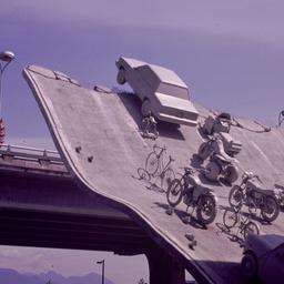 Gray vehicles at end of und...