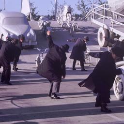 People in overcoats and hat...