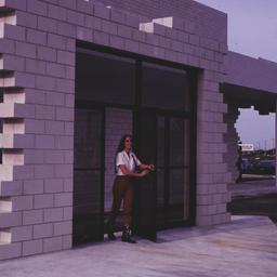 Woman in freestanding doorway.