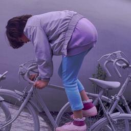 Child riding gray bicyle.