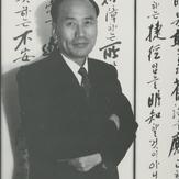 A Korean man in a suit is s...