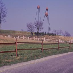 Sculpture in field, seen fr...