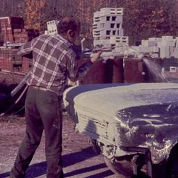 Men covering car in concrete.