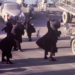 People in overcoats and hat...