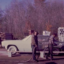 Men covering car in concrete.