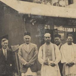 Group of five men standing ...