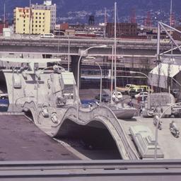 Gray vehicles on undulating...