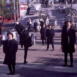People in overcoats and hat...