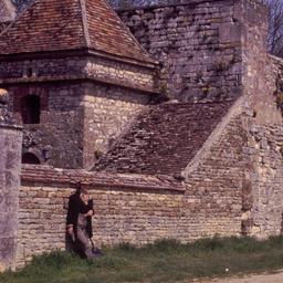 Woman leaning against stone...