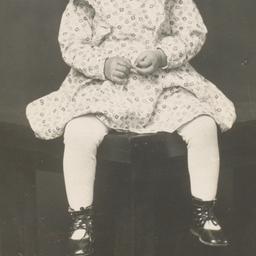 [Child in a Dress Sitting o...