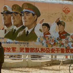 Two Tibetans walking past s...