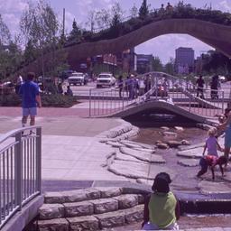 Visitors in plaza with brid...