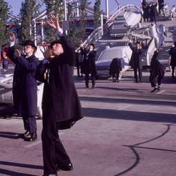 People in overcoats and hat...