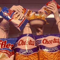 Hands emerging from chip bags.